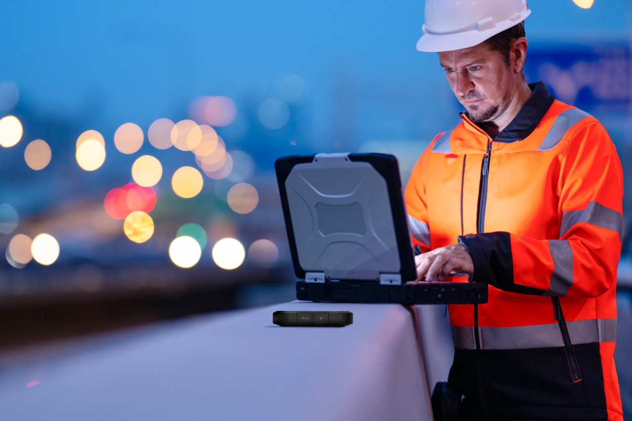 Construction worker typing on device on-site